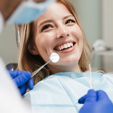 Woman's smiling with dental tools